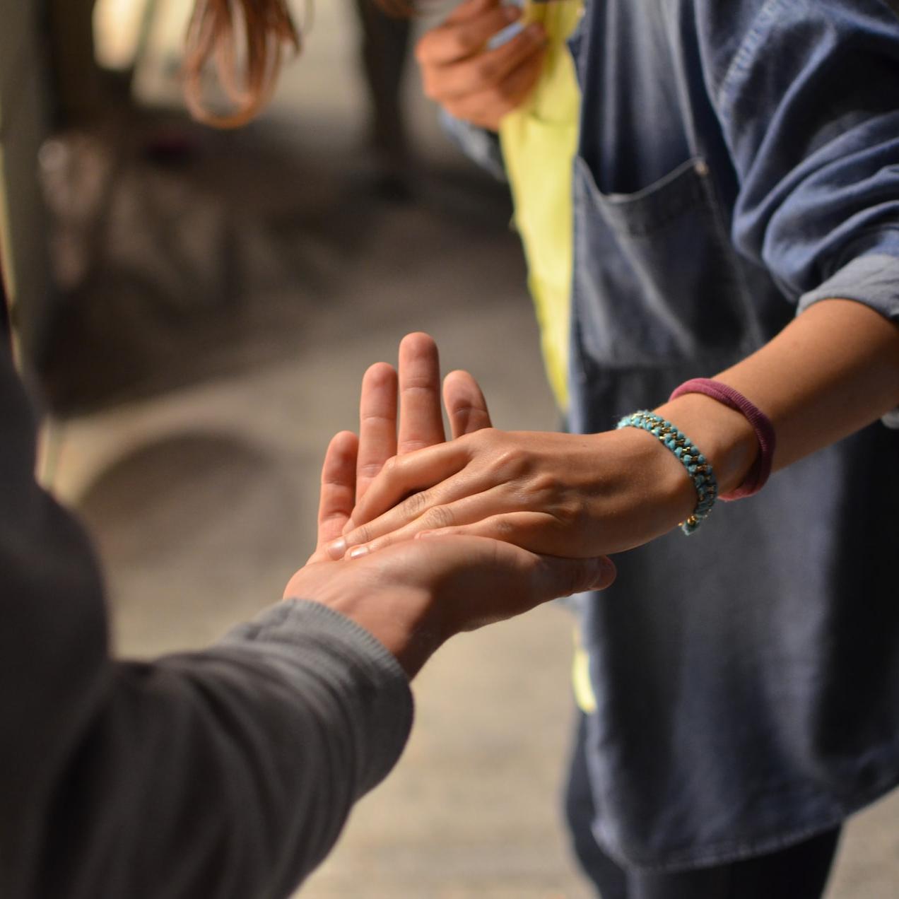 man and woman holding hands on street